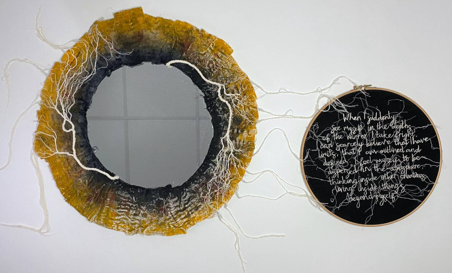 *Underland – Eye contact*, mixed media textile and glass sculpture, deconstructed, repurposed fabrics, second-hand mirror, couched recycled rope thread, acrylics, embroidered text on linen, mounted in wooden embroidery hoops, 55 x 95 x 3cm