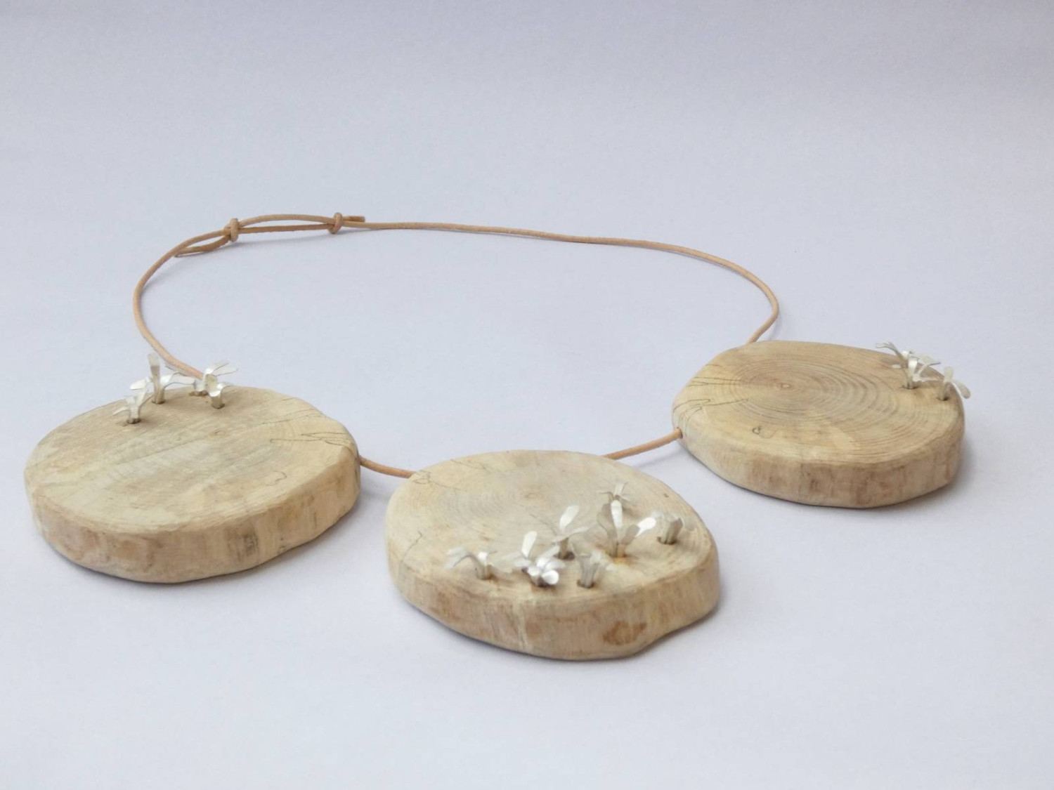 *Life Lines*, neckpiece. Wood (ash), sterling silver, leather cord