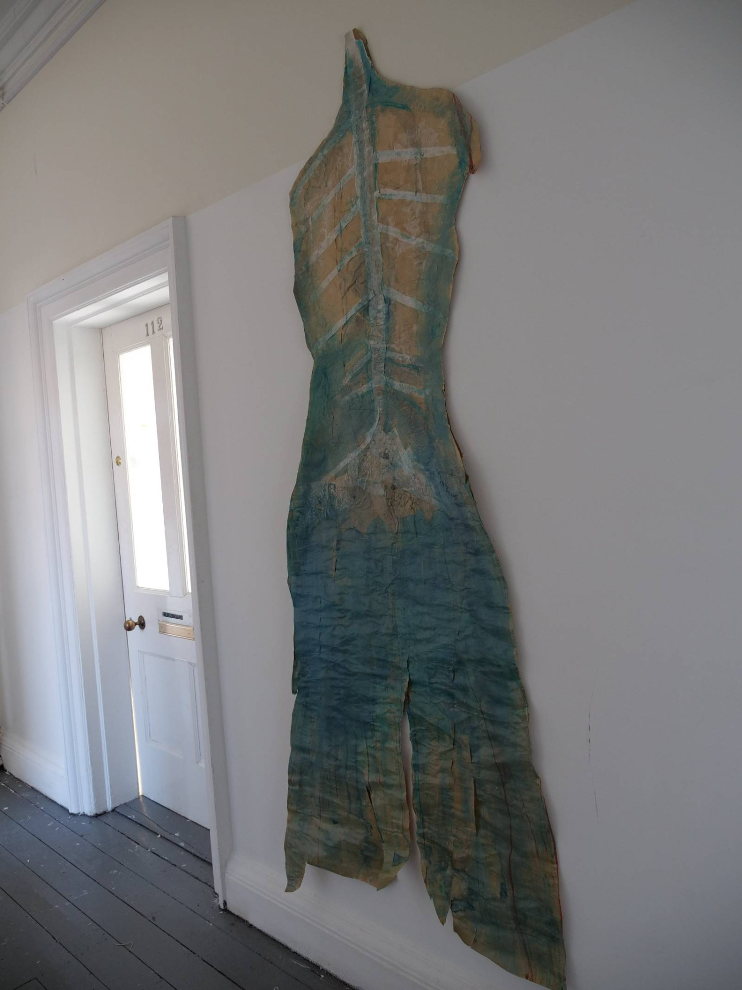 *Distancing Device with Selkie skin*, foam board, jesmonite, paint, white rug underlay with paint, 60 x 93cm