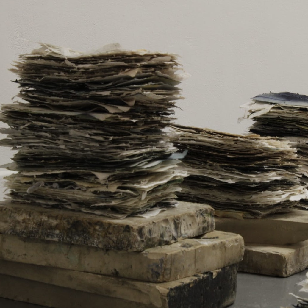 *If I am the sea, where am I?*, handmade paper stacks on lithography stones, installation